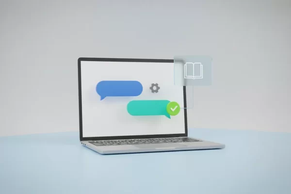 Minimalist 3D laptop showing a live chat interface with chat bubbles, a gear icon, and a green checkmark on a soft gradient background.